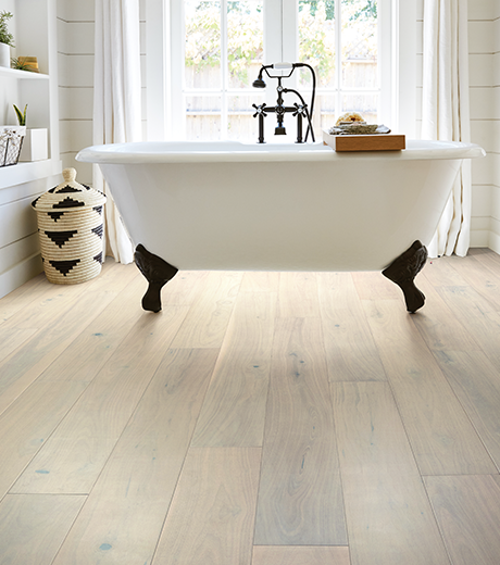 A white bathtub in the middle of the rooom.