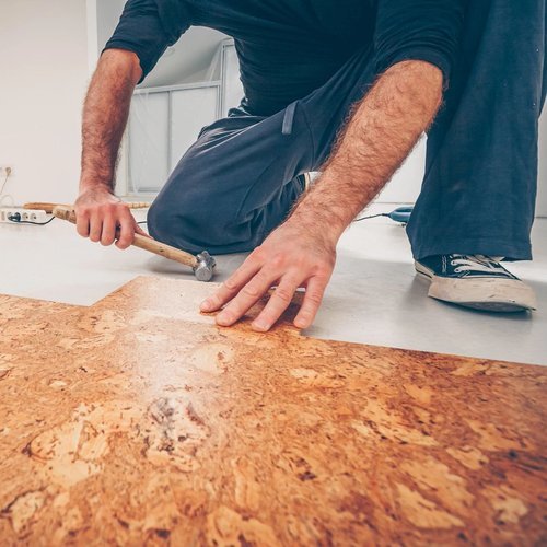 A man installs cork flooring from Sams Floor Covering in Winchester, KY